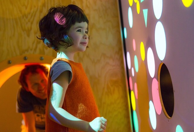 Ein kleines Mädchen ist fasziniert vom riesigen Konfetti-Bildschirm. Wenn er will, kann der Papi seine Tochter durch den Kriechtunnel jederzeit erreichen.
